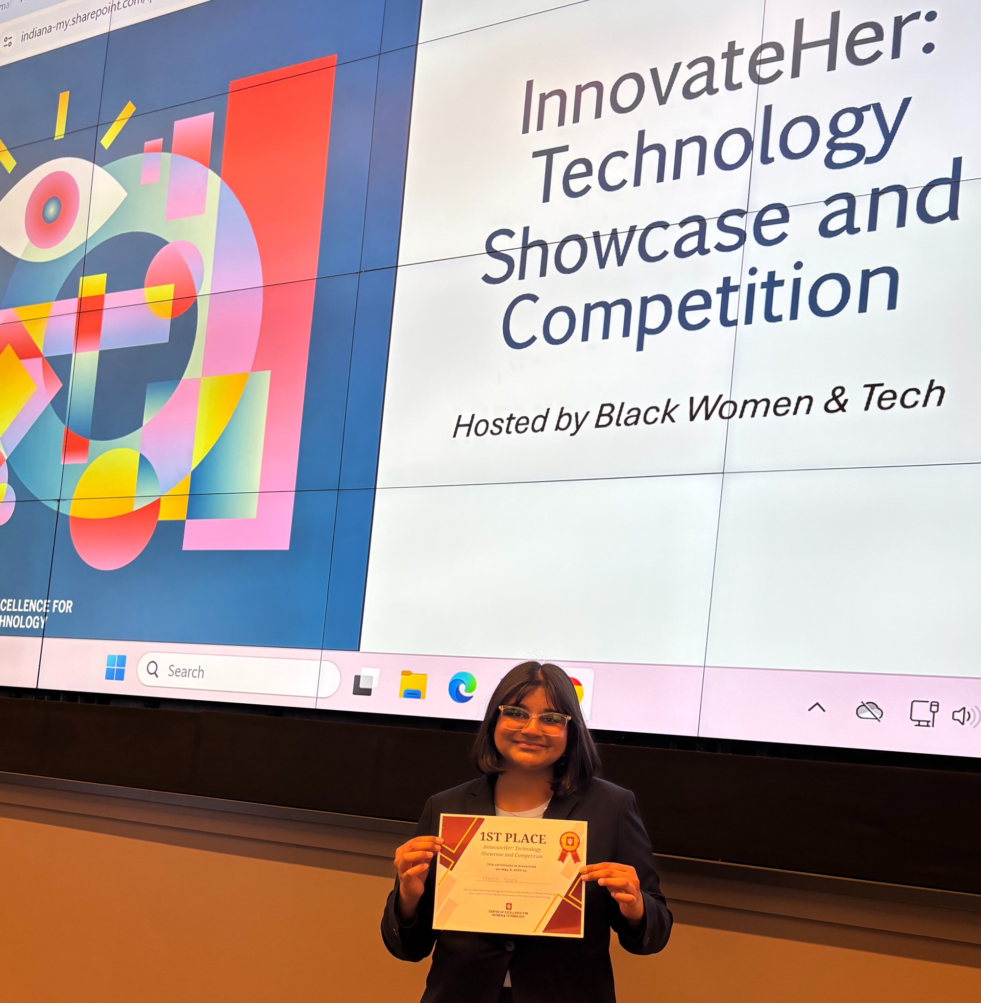 Holding the InnovateHer first place certificate